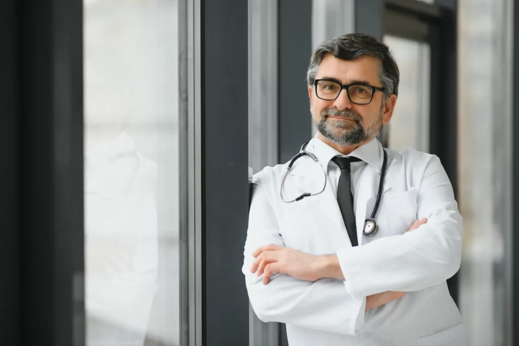 confident doctor in white coat with stethoscope utc